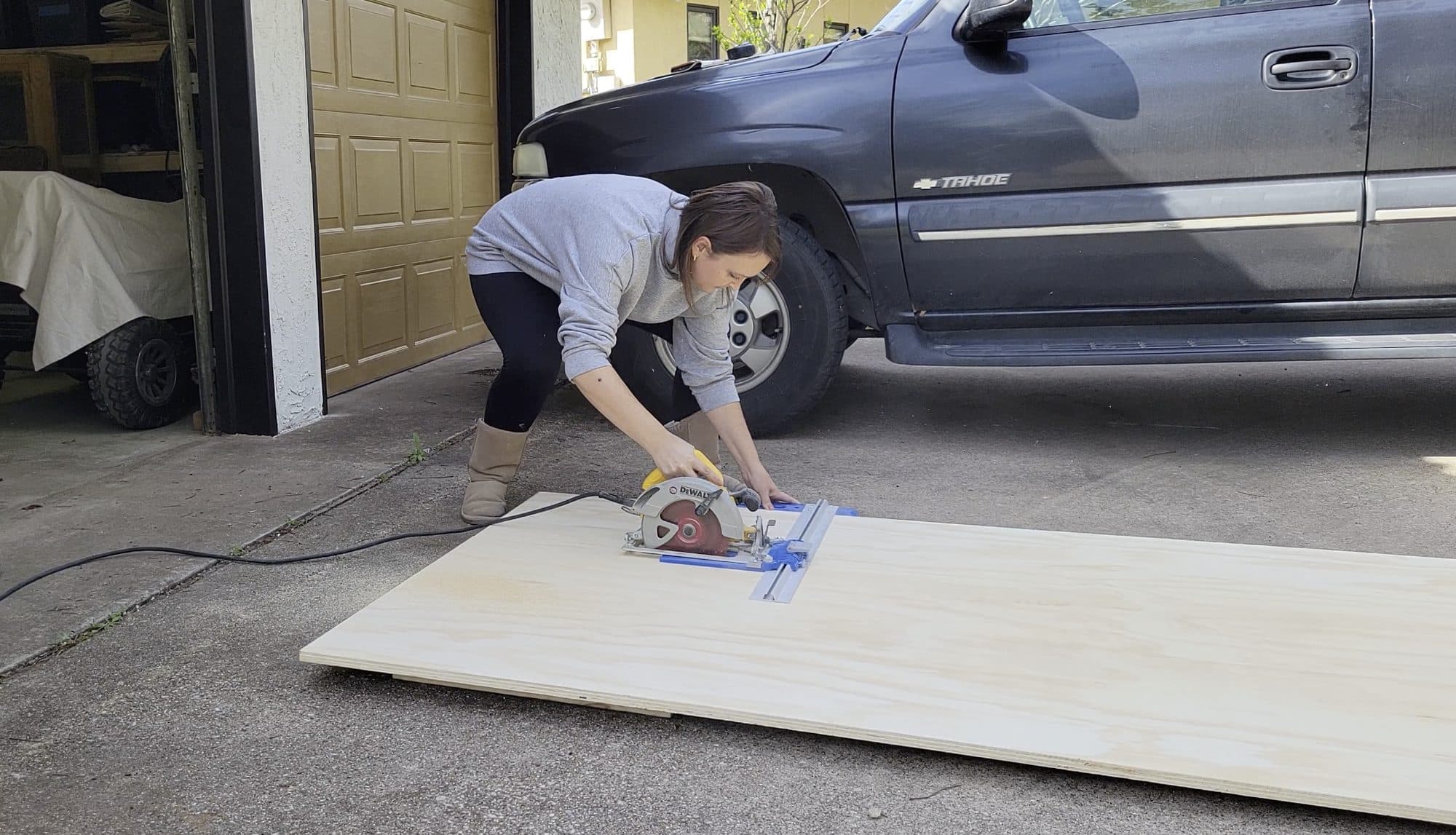 Savana cutting a sheet of plywood with a circular saw